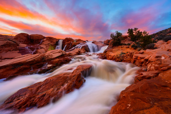 sunset over waterfall on red rock